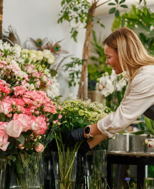 Woman florist small business owner standing in floral store. High quality photo